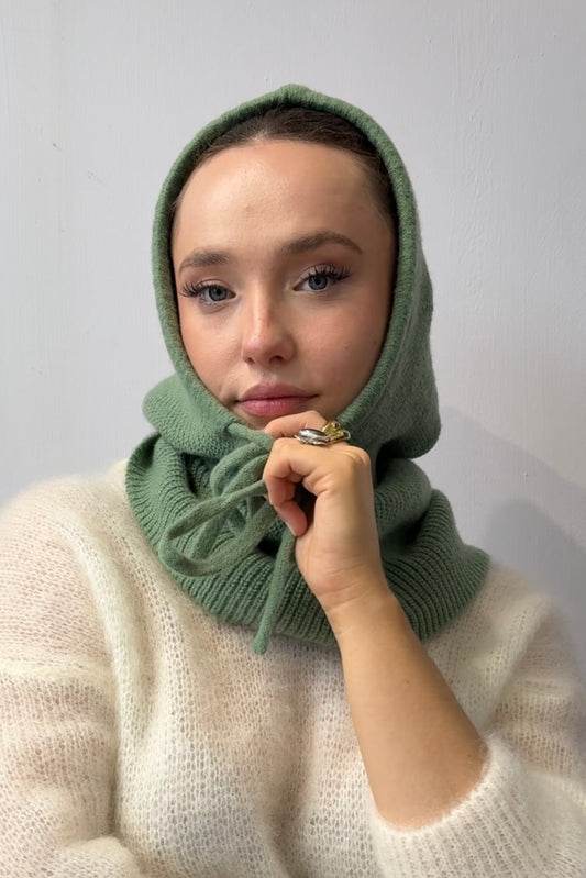 woman wearing a green cashmere balaclava 