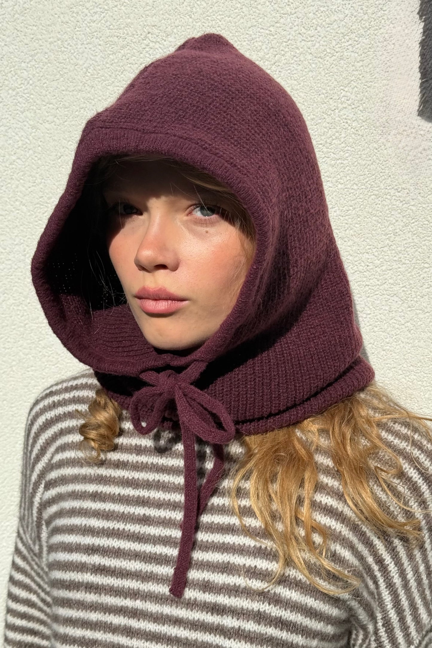 woman wearing a burgundy  cashmere balaclava