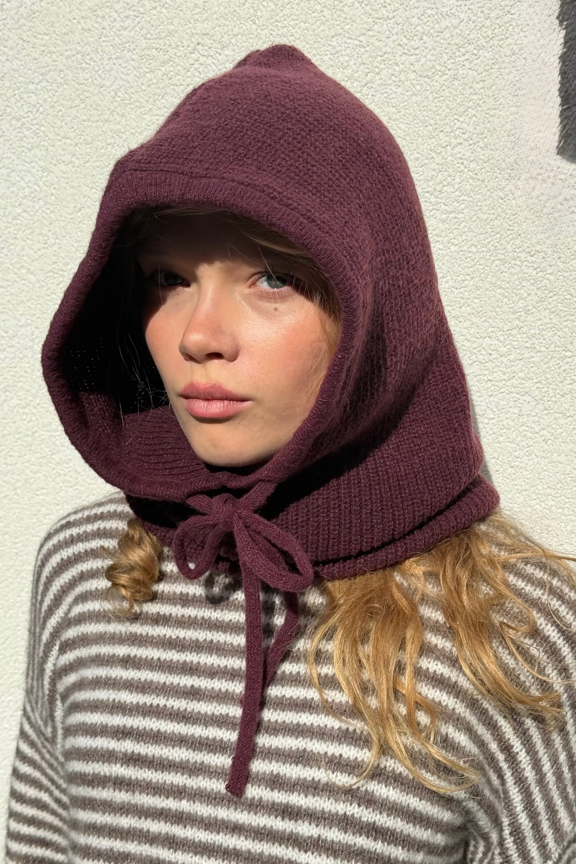 woman wearing a burgundy  cashmere balaclava