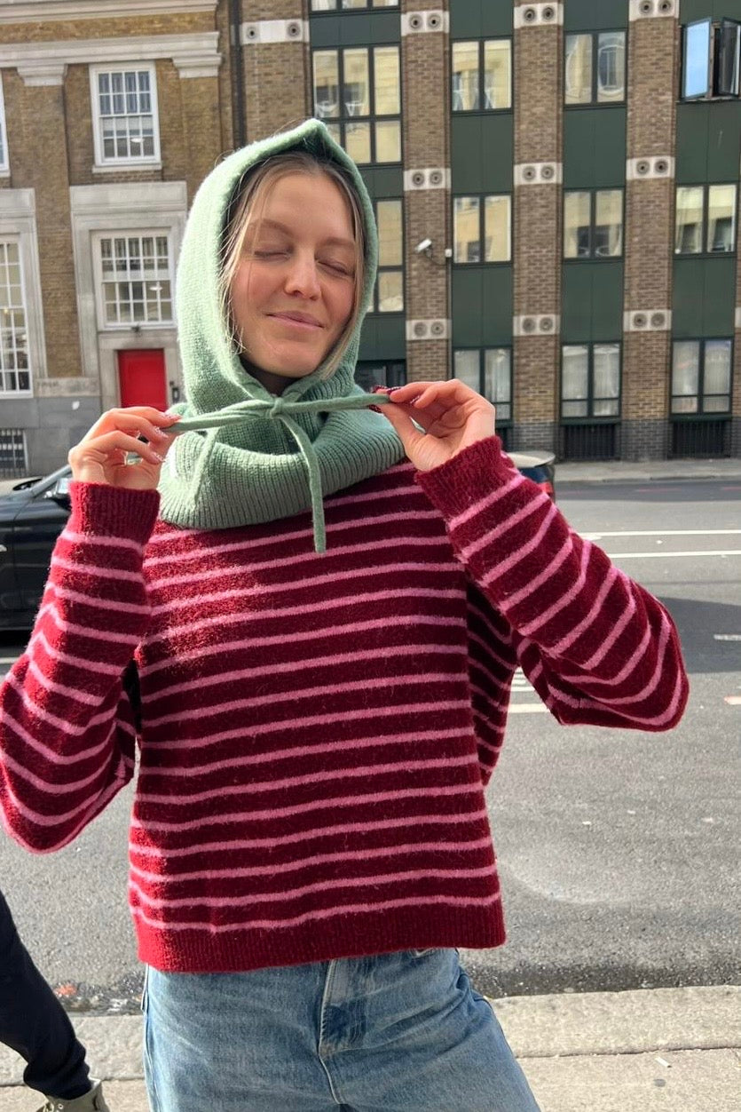 woman wearing a green cashmere balaclava